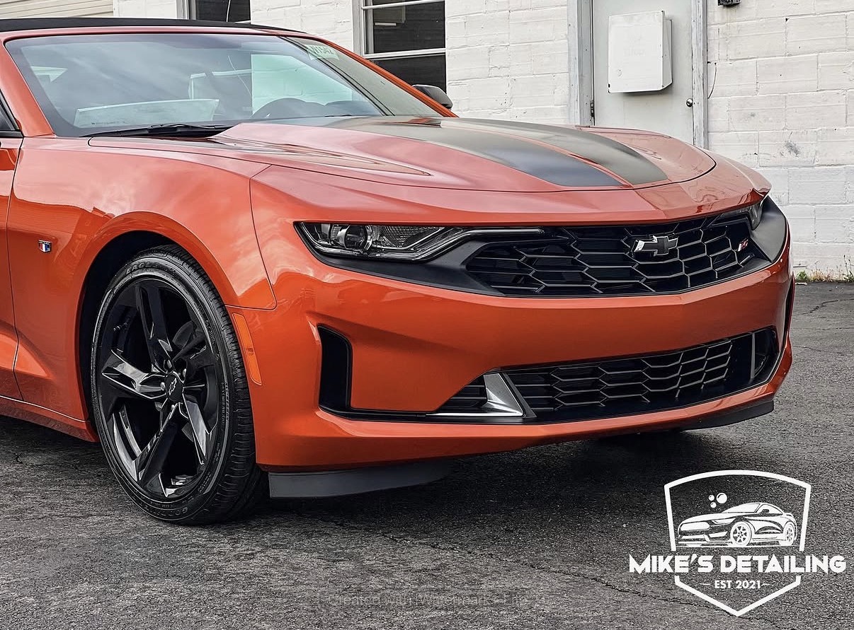 Orange Chevrolet Camaro front close-up after exterior detail