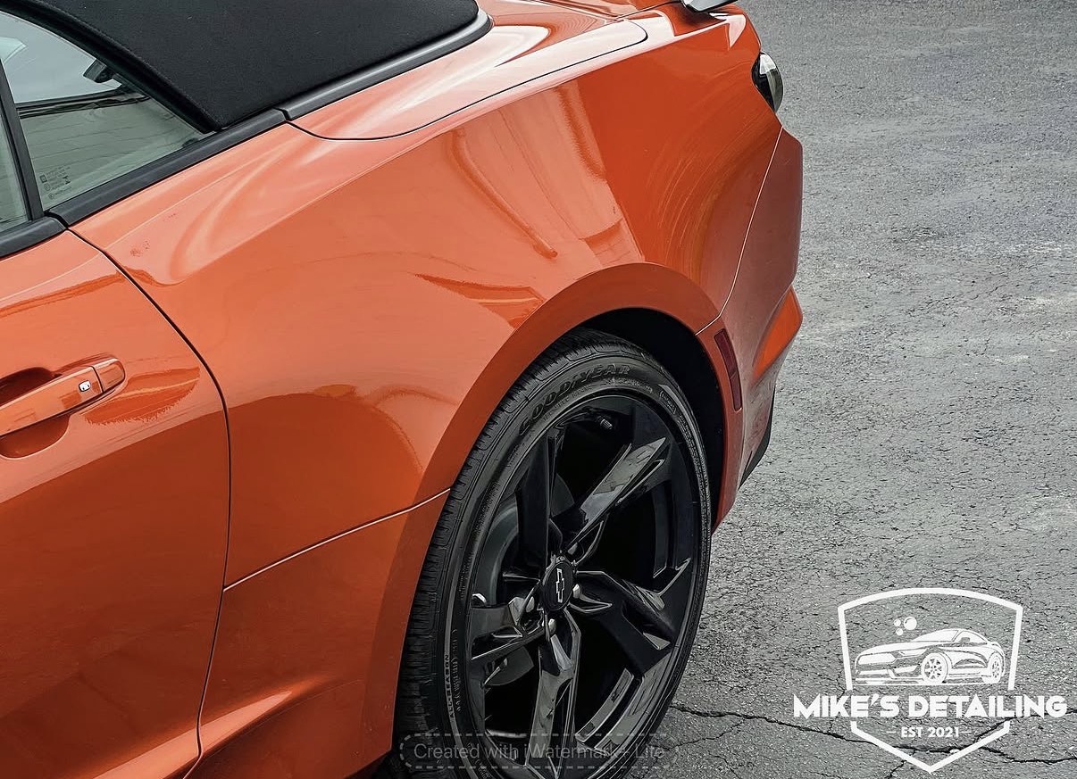 Orange Chevrolet Camaro rear quarter panel after detail