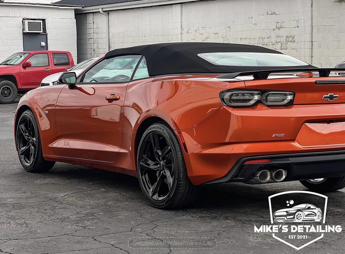 Orange Chevrolet Camaro rear side after exterior detail