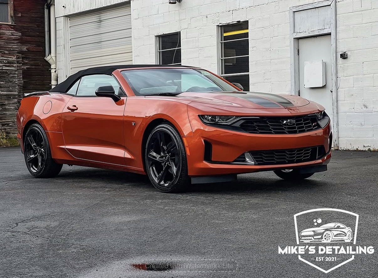 Orange Chevrolet Camaro after exterior detail side angle