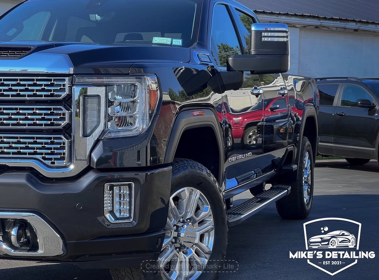 Black GMC Denali truck with glossy exterior finish