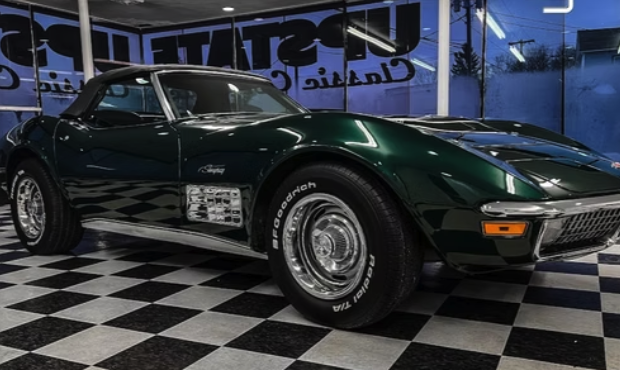 Green classic Corvette side profile in the shop