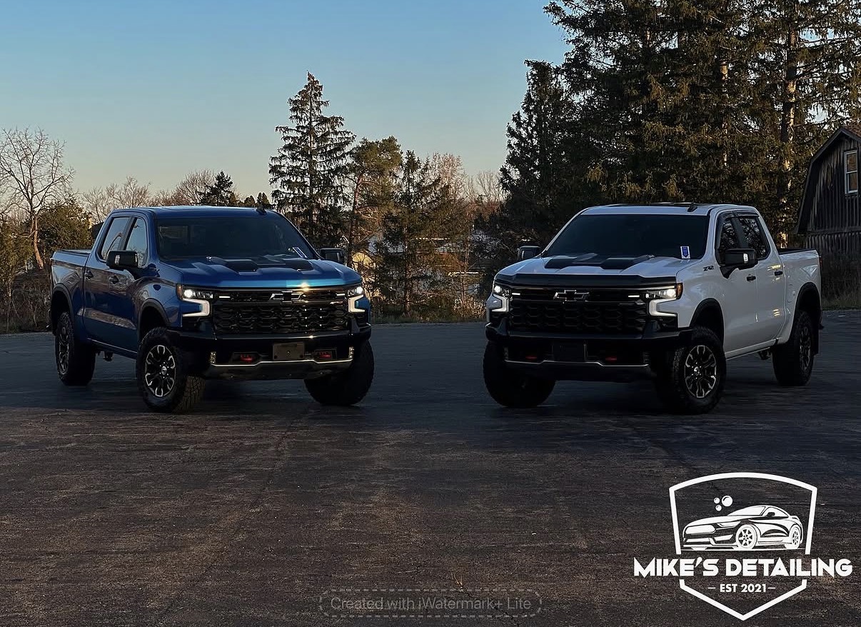 Two Chevrolet trucks detailed outdoors